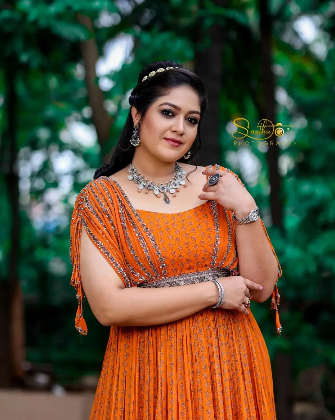 Meghana Raj Wearing Beautiful Earring Jewellery Orange Gown